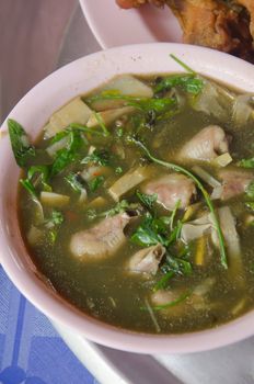 A savoury thick soup made from chicken , spices and vegetables