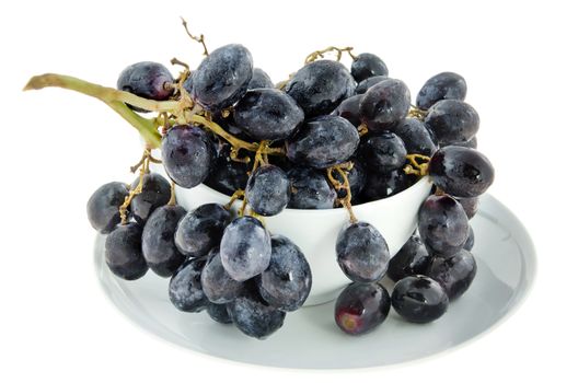 ripe grapes  fruits in white bowl  over white background