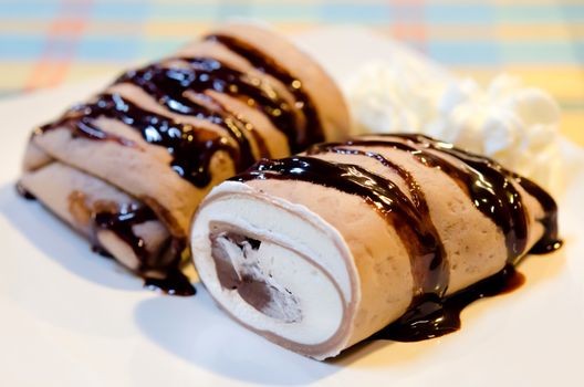 crepe rolls filled  with white cream and chocolate  , topping with chocolate  syrup