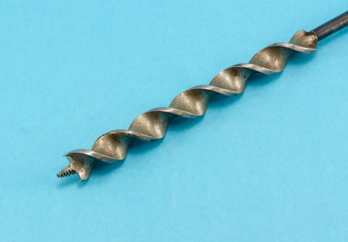 special wood drill bit on blue background.