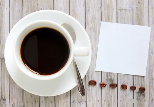 Blank paper with hot coffee cup and coffee beans
