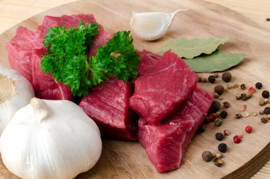 Fresh raw meat on wooden board.