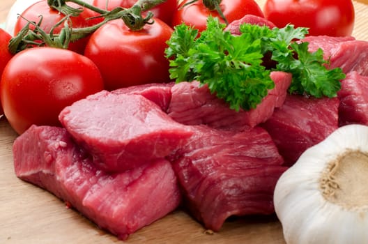 Fresh raw meat on wooden board.