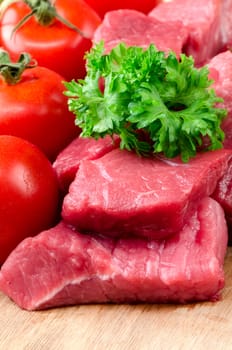 Fresh raw meat on wooden board.