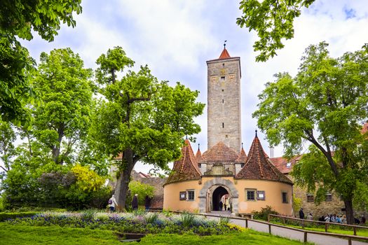 Castle gate in Rothengurg ob der Tauber with green trees, Bavaria, Germany in spring