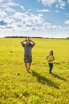 Family walking in a field