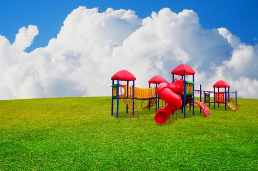 Colorful children's playground in garden with nice sky background