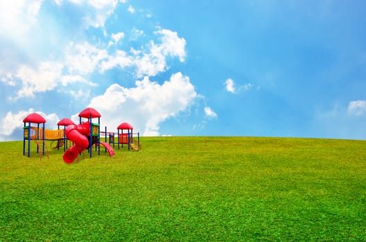 Colorful children's playground in garden with nice sky background