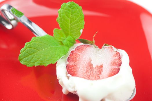 ice cream with mint,spoon and strawberry