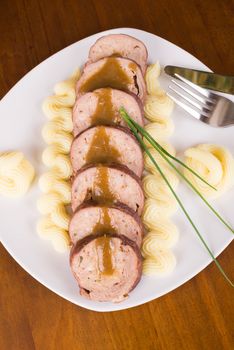 Beef roulade served with a butter garnish