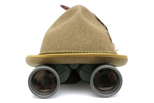 arrangement with oktoberfest hunting hat and binoculars over white background