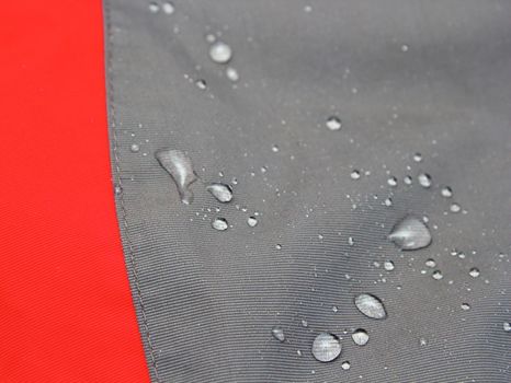 detail of waterproof outdoor jacket - you can see liquid drops on the water repellent material