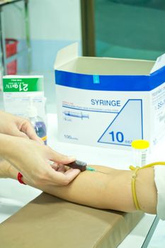 Doctors Having Blood Test of patients to health