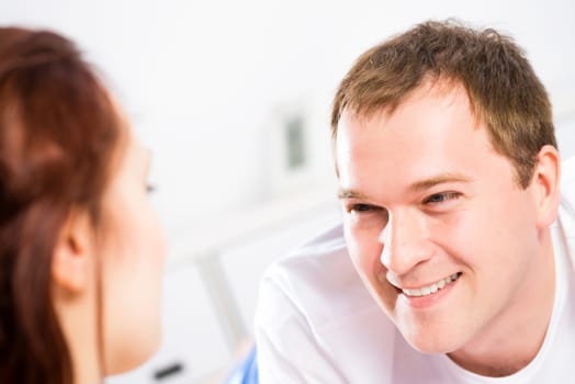 young man lying in bed with his girlfriend, spend time together at home