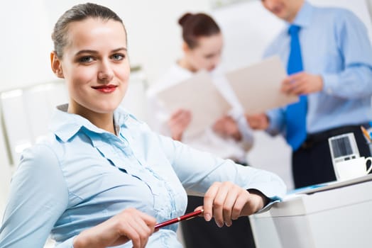 portrait of a business woman in office, smiling and looking into the camera, office work