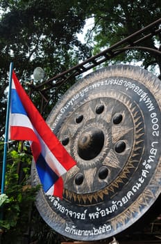 Thai National Flag and a traditional Buddhist bell