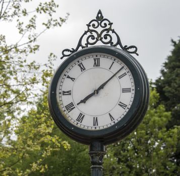 old iron clock on train station