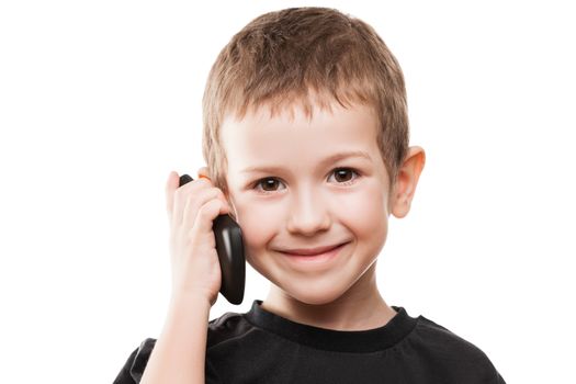 Little smiling child boy hand holding mobile phone or smartphone white isolated