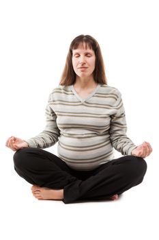 Healthy lifestyle and pregnancy - beauty pregnant woman meditating in yoga exercise