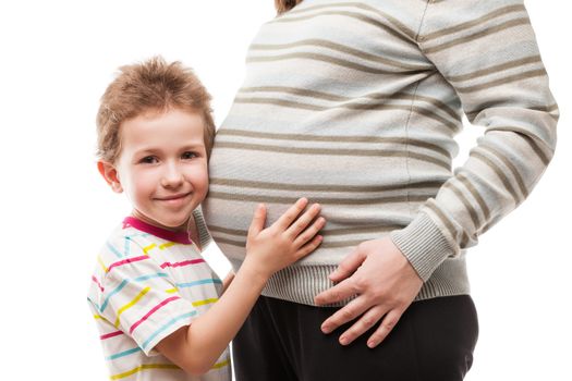 Pregnancy and new life concept - little child boy touching or bonding pregnant mother abdomen