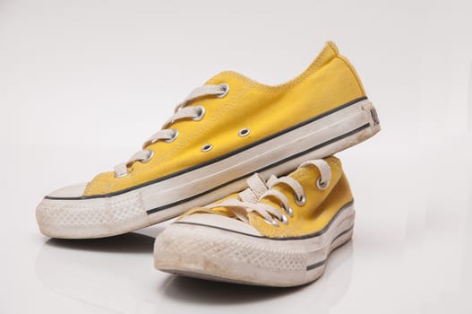 Yellow colored sneakers with white laces