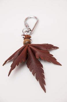 peculiar keychain with a marijuana leaf brown