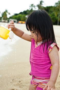 Young toddler at the beach having fun and is curios