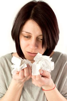 sneezing woman holding tissues, allergy or cold flu concept