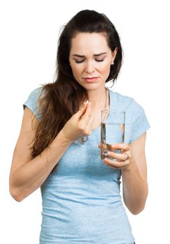 A woman suffering from headache, pain  or migraine taking a painkiller pill. Isolated on white.