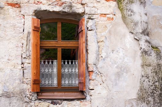 Old window with shutters and lace curtains