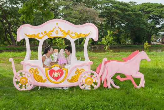 Asian Thai bridal with the wedding teddy bear in romantic carriage with love theme as the Prince and Princess.