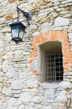 Old wall made from stone with window and streetlight