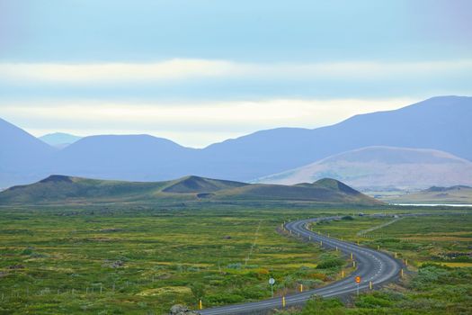 Highway through Iceland landscape at foggy day. Horizontal shot