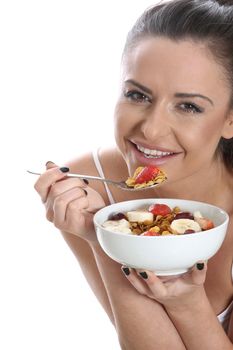 Model Released. Young Woman Eating Breakfast Cereal and Fruit