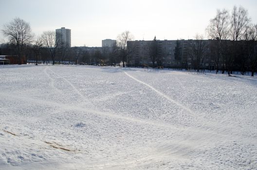 school stadium in the winter people and bicycles traces