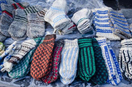 lot of warm woven knit wool woollen sox socks stockings sell in outdoor street market fair.