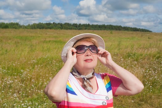 Woman wearing sunglasses on the field