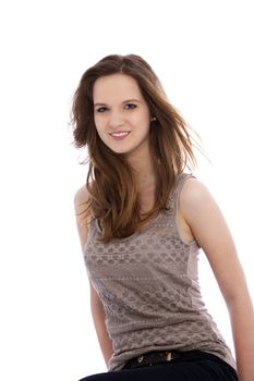 Low angle portrait of a trendy shapely young woman sitting looking down at the camera isolated on white