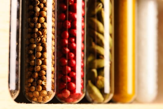 Spices in beakers against dark background