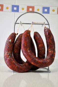 sausages hanging on a hanger in kitchen