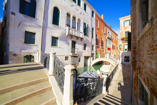 Beautiful romantic Venetian scenery. Street, canal, bridge. Venice. Italy