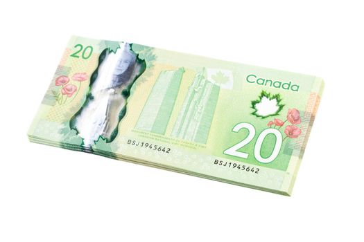 A stack of new polymer Canadian twenty dollar bills, isolated on white background