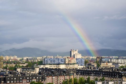 View over Ljubljana districts with rainbow casted in the sky.