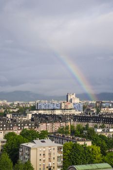 View over Ljubljana districts with rainbow casted in the sky.