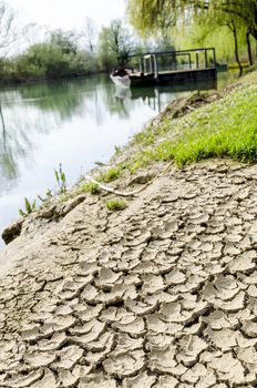 Dried and cracked soil at river band.