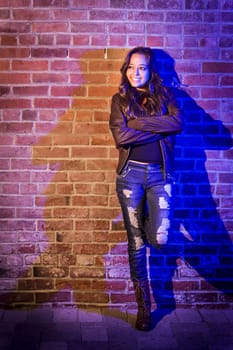 Portrait of a Pretty Mixed Race Young Adult Woman Against a Brick Wall Background.