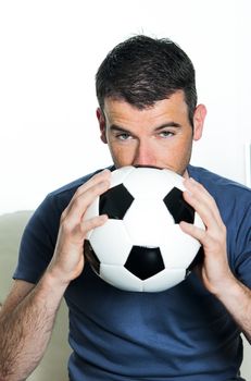 closeup of passionate soccer player with white and black balloon