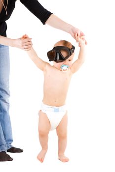 child with swimming mask learning to walk
