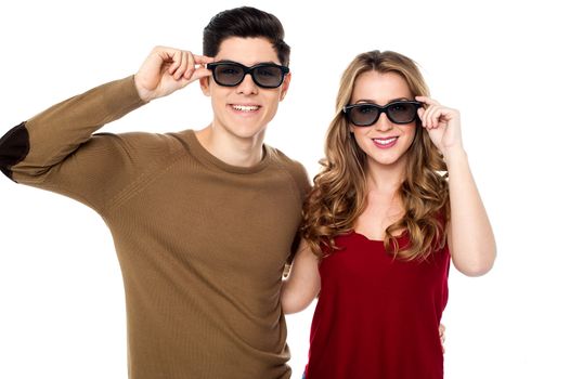 Attractive young smiling couple adjusting their goggles