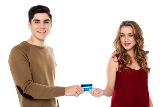 Handsome guy giving credit card to his girlfriend for shopping